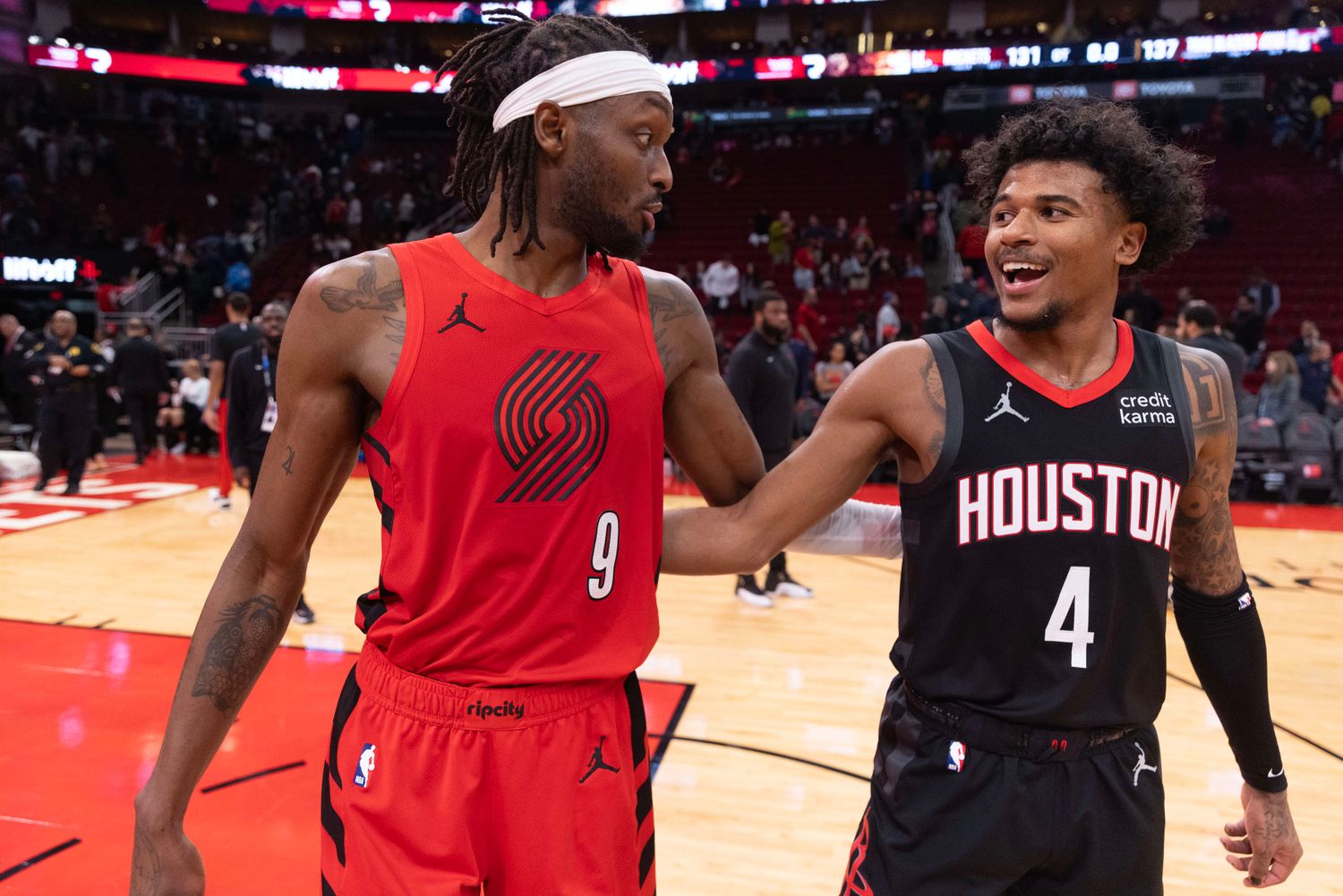 Trail Blazers forward Jerami Grant (9) hugs Houston Rockets guard Jalen Green (4) after their game at Toyota Center.
